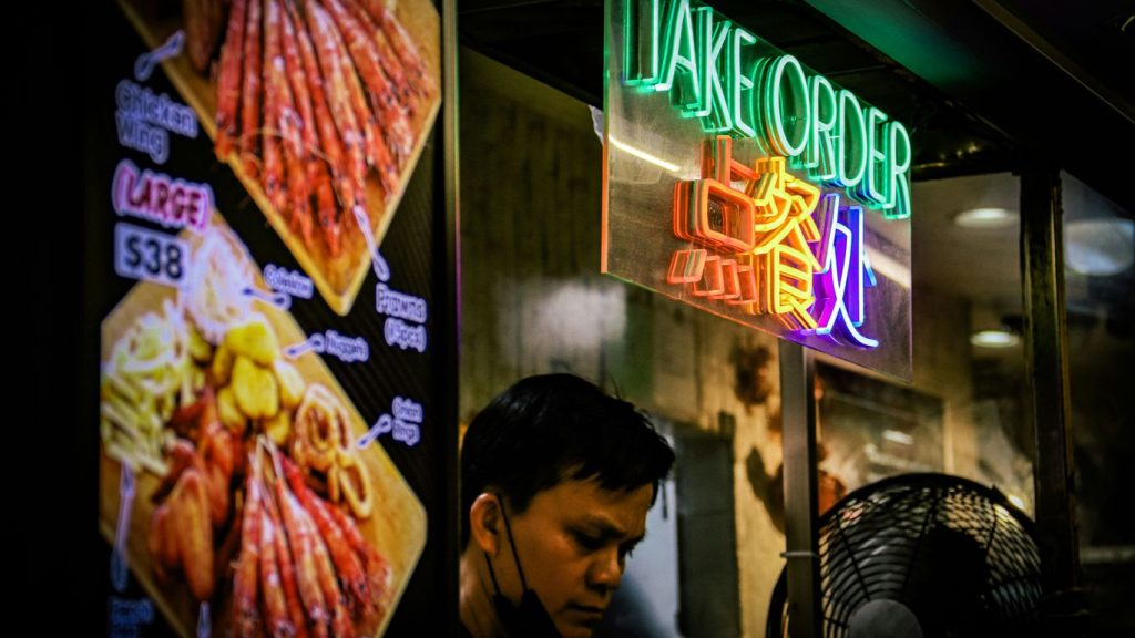 A man standing outside of a chinese restaurant